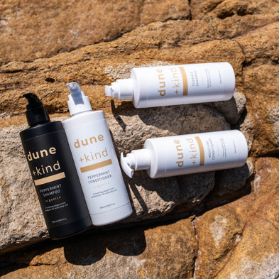 Dune Skin skincare products on a rocky surface