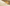 Gold dropper with liquid on a textured beige surface